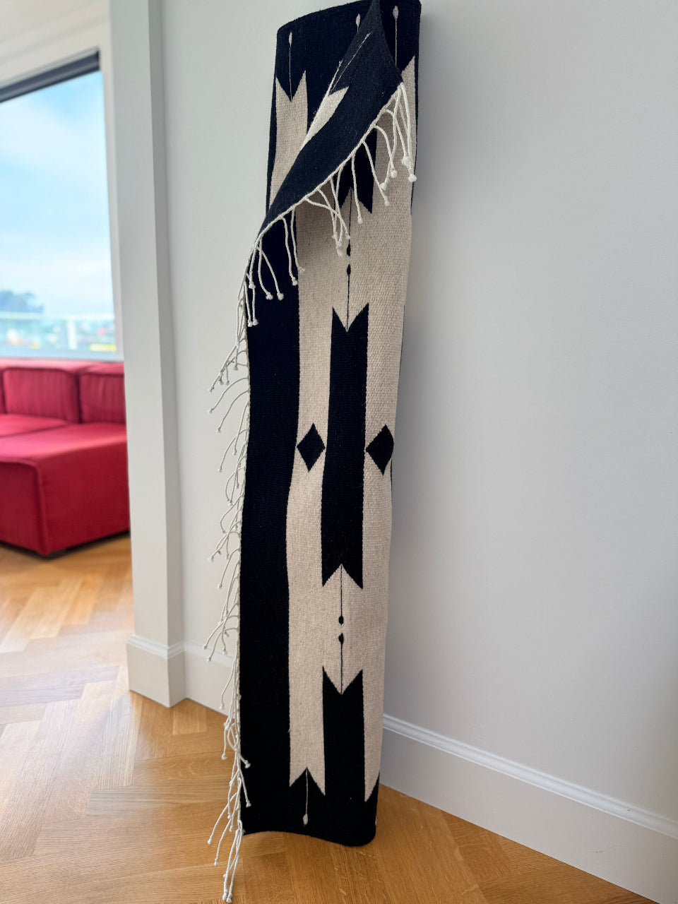 Handmade wool rug, modern pattern on white background. made by Zapotec weavers in Oaxaca, Mexico, using natural wool and dyes