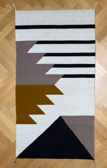 Full picture  of Handmade wool rugs with geometric pattern in black, brown, white and okra color. Rug made in Oaxaca, Mexico by Zapotec weavers. 